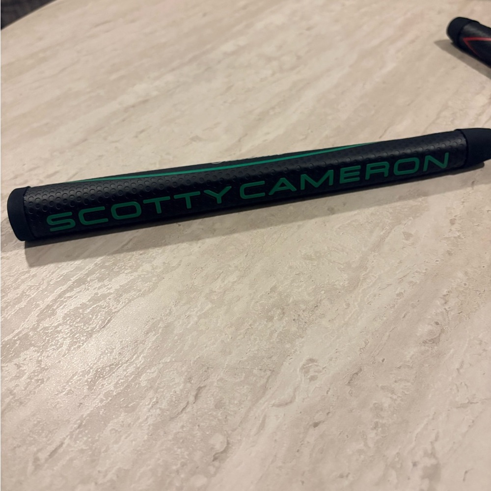 Scotty Cameron Black Grip with Green  Lettering